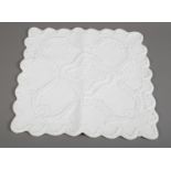 Boutis/ Fine French quilting: A small white cover with scalloped edges, made in the Boutis method