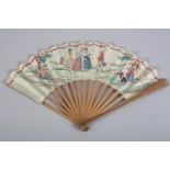 A late 18th century French Revolutionary period paper fan, the leaf mounted on simple tan wood