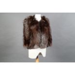 A vintage waist-length silver fox fur cape with slits to slip the arms through, unlabeled, lined