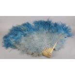 Fan Dancing! An oversized shaded blue ostrich feather fan with stout monture in wood painted