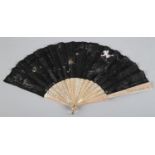 A circa 1880's fan with plain but striking pink mother of pearl monture, the black gauze leaf