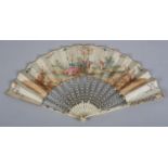 A mid-18th century ivory fan, the monture carved, pierced and silvered, the vellum leaf mounted à