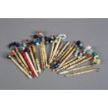 Lace bobbins: twenty-two bone bobbins most with spangles, one dyed cerise, some with wire or other