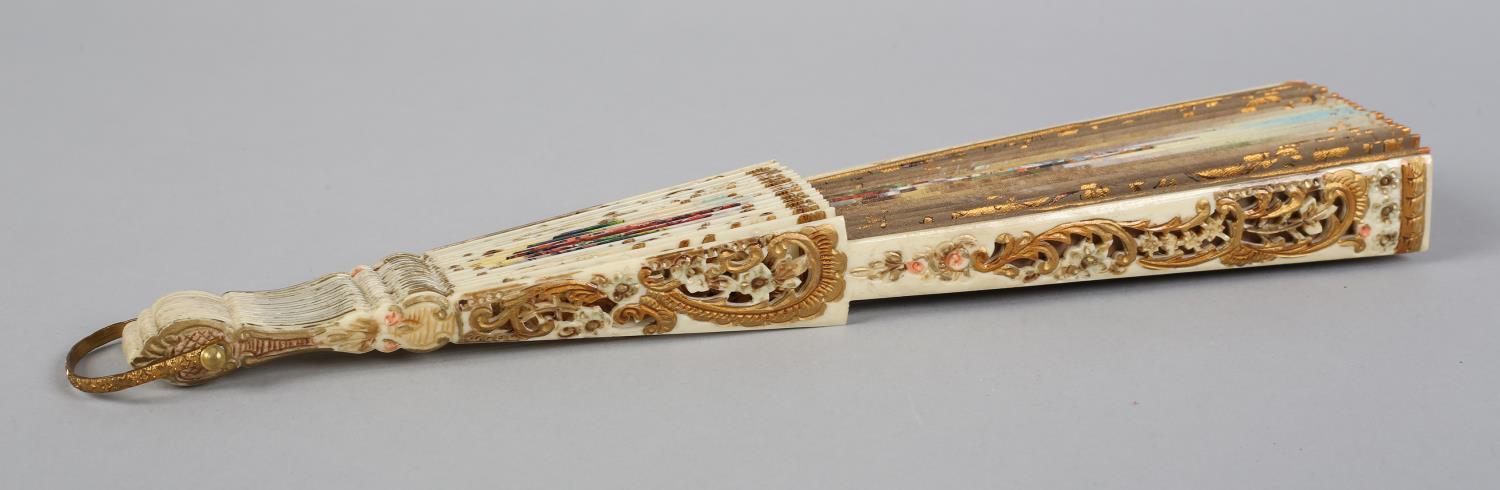 A 19th century bone fan, highly decorated, the monture carved and pierced and painted in strong - Image 6 of 6