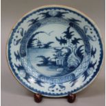 An 18th century delft plate painted in blue and white with a pagoda island river landscape, 23cm