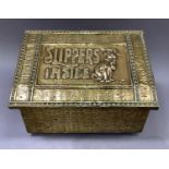 A brass covered slipper box, the sloped lid embossed with 'Slippers Inside' and a dog, 35.5cm wide