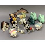 A Poole pottery otter, Sylvac dog, two Sylvac style rabbits, pair of piggy banks, other animal