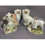 A pair of Staffordshire spaniels, a Staffordshire figure group of milk maid and cow and a lion and