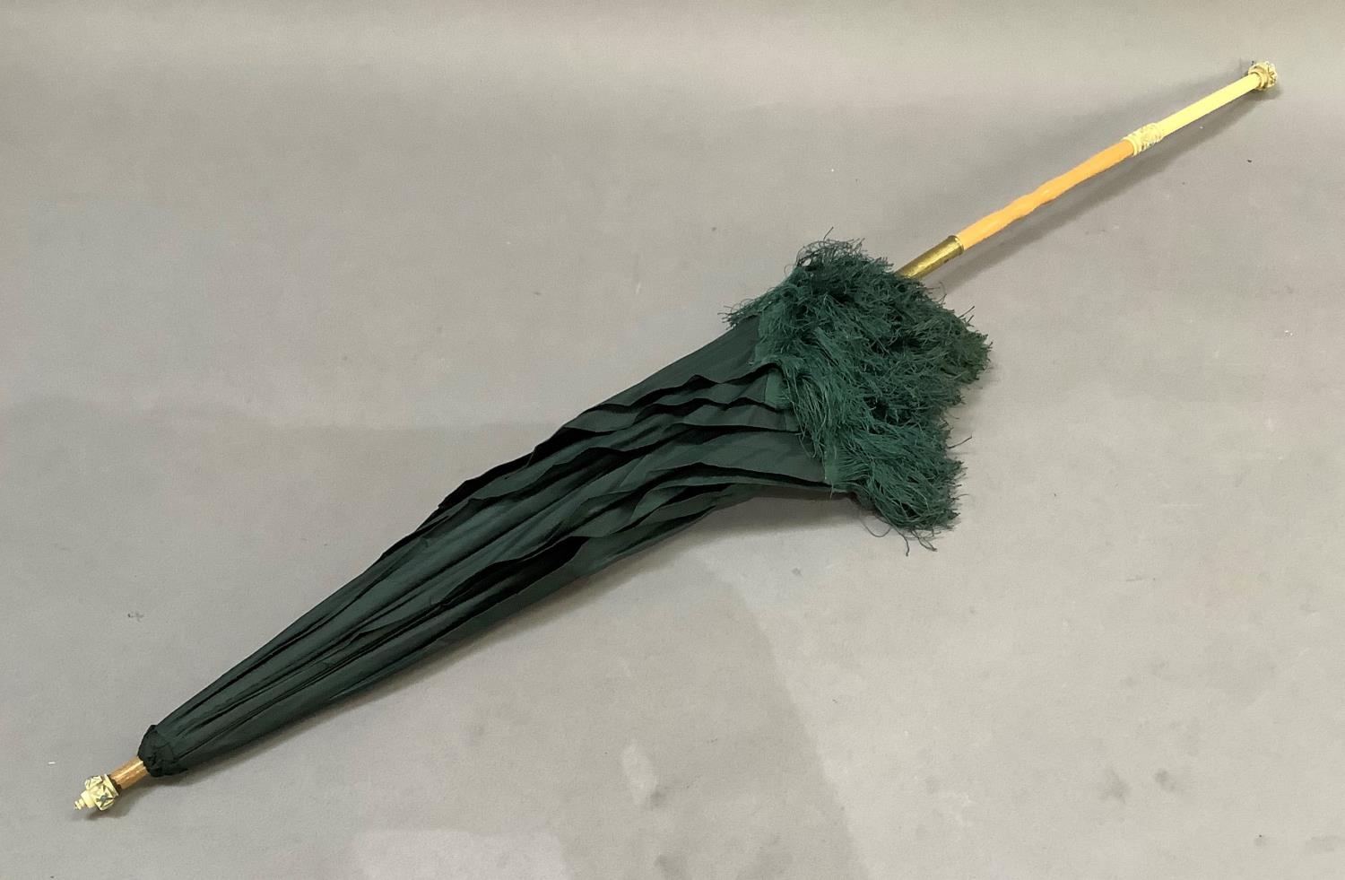 A Victorian dark green silk parasol with ivory handle set with turquoise beads