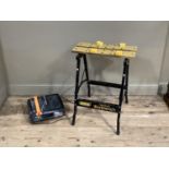 A folding work bench together with a tile cutter