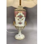 A 20th century Dresden china table lamp of two handled urn shape painted with sprays of flowers