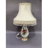 A milk glass vase painted with an angel and flowers to the reverse within gilt scroll surround,