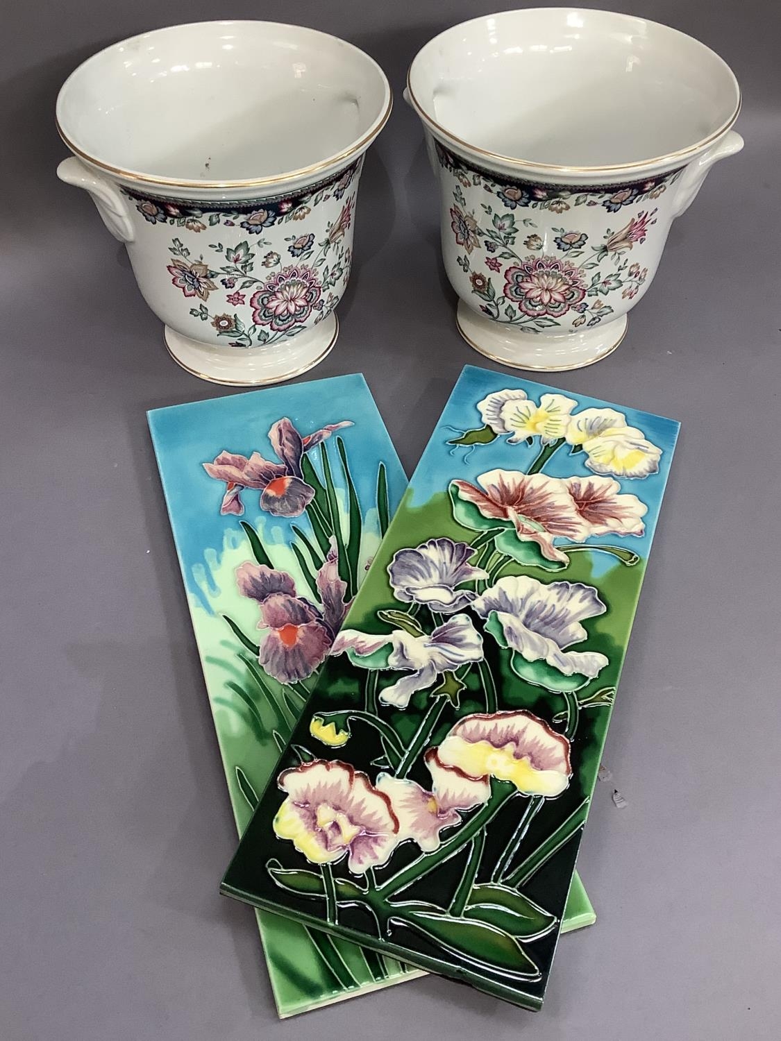 A pair of rectangular ceramic tiles, tube lined and glazed in floral design together with a pair