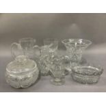 A cut glass powder bowl and cover, ale glass, wine with faceted bowl and stem, water jugs, helmet