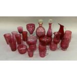 A quantity of mainly cranberry glass including decanter, ewer, large goblet, water glasses,