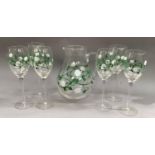 A Pimms set of jug and six long stemmed glasses all painted with trailing white flowers and