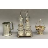An EPNS and glass four bottle breakfast cruet in with loop handle, an EPNS preserve basket and