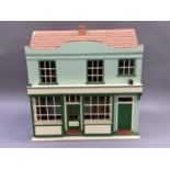 A dolls house and shop, fitted with furniture throughout