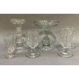 Two 19th century glass stands with dished tops and baluster stems, on circular domed foot, measuring