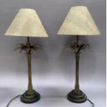 A pair of metal table lamps in the form of palm trees with snakeskin effect shades, 54cm to