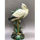 A Victorian Majolica stick stand modelled as a stork before a lily pad and leaf vase, various old