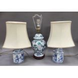 A pair of Chinese style blue and white pottery table lamps and another of floral baluster design