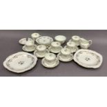 A Coalport tea service of Burgundy pattern, gilt on a white ground, eight cups, seven saucers (one