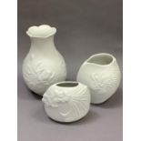 Three Kaiser white bisque vases including baluster shape moulded with roses no.635, incised
