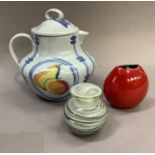 A Buchan Portobello, Scotland stoneware jug, the domed lid with looped handle, painted with fruit,