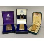 Three vintage lighters all in original cases including Dunhill 70 in gilt case, a Dunhill Rollagas