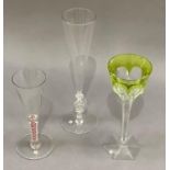 An 18th century style wine glass with funnel bowl, red and opaque double twist stem on circular