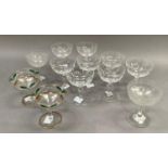 A set of six cut glass champagne flutes and six others