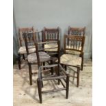 A harlequin set of seven rush seated country chairs with spindle and bobbin backs