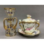 An English porcelain two handled chocolate cup, cover and stand having a butterfly finial winged