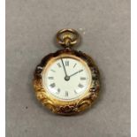A lady's 19th century fob watch in 18ct gold foliate scroll engraved scalloped case No. 7147 Swiss