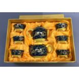 A Chinese eight piece tea service decorated with a border of two opposing dragons chasing the