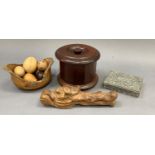 A Dunhill tobacco storage jar, circular outline, a wooden fruit bowl with fruit, a carved nut