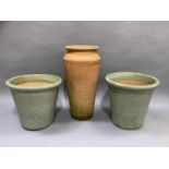 A pair of celadon green glazed plant pots and a tall earthen ware planter, 37cm diameter by 32cm