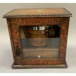 An early 20th century oak and glazed smoker's cabinet together with a chrome lidded jar, 26cm high