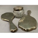 A silver lidded cut glass toilet jar 9cm diameter together with a pair of silver backed hand mirrors