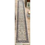 A Persian style runner, the ivory field all over woven with plant forms, birds and animals within