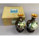 A pair of 20th century Chinese cloisonné vases of baluster form enamelled with a ribbon tied spray