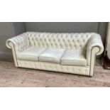 A cream buttoned leather Chesterfield three seater sofa, approximately 196cm wide