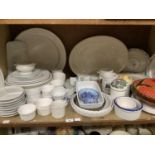 A quantity of modern table pottery including large platters and plates, ramekins, flan dishes,