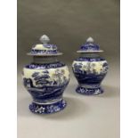 A pair of Spode blue and white baluster vases and domed covers with knopped finials, printed with