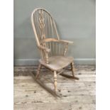 A beech rocking chair having a pierced splat and rail back