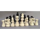 A garden chess set in black and white plastic