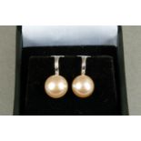 A pair of cultured pearl earclips in silver, each approximately 9mm