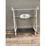 A French cream finished metal towel rail of scrolled form, with plaque lettered 'Le Bain'