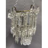A two tier basket chandelier hung with prismatic drops